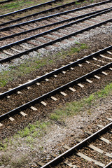 Railway top view background. Train transport industry. Vertical rail track texture. Good and cheap way of transportation for cargo. Old railroad wooden tie. Track ballast gravel made of crushed stone.