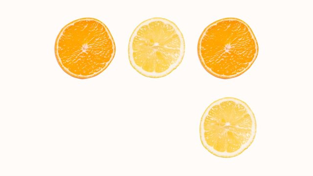 Stop motion oranges and lemons appear, disappear and spin against a light background
