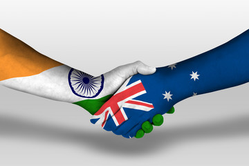 Handshake between Australia and india flags painted on hands, illustration with clipping path.