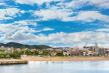 Coast of Miura Peninsula with palm fringed Kurihama beach in Yokosuka town facing the Uraga Channel off the Tokyo bay.