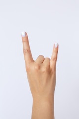 Gesture and sign, hand on a white background. Hand showing rock