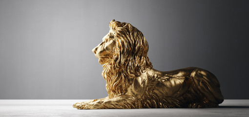 Golden statue of lion, a sculpture. Concept of a strength, power