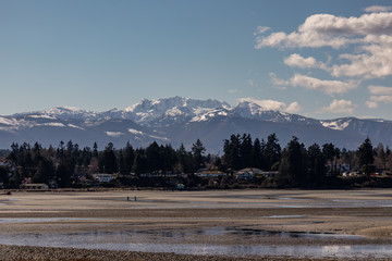 snow-covered mountains Mount Arrowsmith view from a sandy beach Parksville