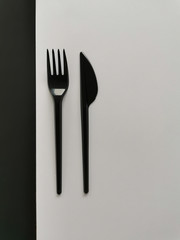 black  fork and knife isolated on black and white background