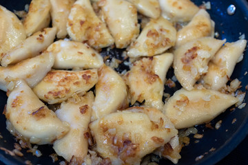 Perogies in a pan with onions