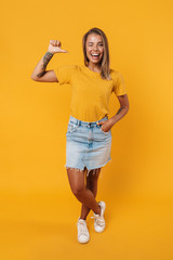 Image of blonde joyful woman winking and pointing finger at herself