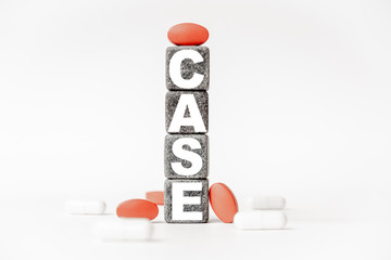 a group of white and red pills and cubes with the word case on them, white background. Concept...