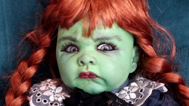 A Scary Green Halloween Doll Moves Its Head By Itself