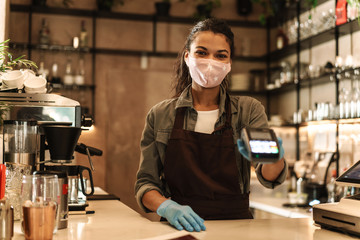 Woman barista wearing medical face mask