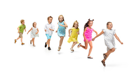 Happy children, little and emotional caucasian kids jumping and running isolated on white background. Looks happy, cheerful, sincere. Copyspace for ad. Childhood, education, happiness concept.