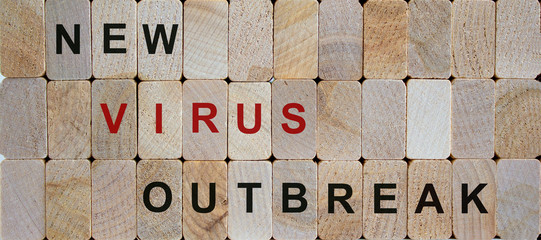 Wooden blocks form the words 'new virus outbreak'. Beautiful wooden background. Covid-19 and medical concept.
