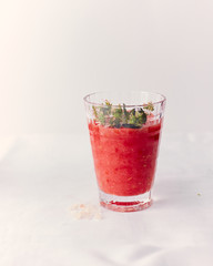 gazpacho soup with herbs on a white background