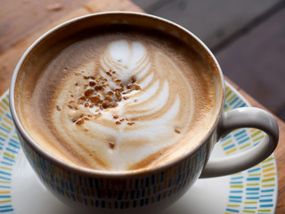 close-up latte coffee topped with rock sugar in cup