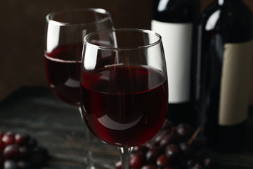 Composition with grape and wine on wooden table, close up