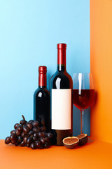 Composition with wine, fig and grape on two tone background