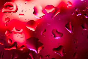 Large drops of water on the glass. Pink, red are the colors of love. Macro mode. Background. Copy space.