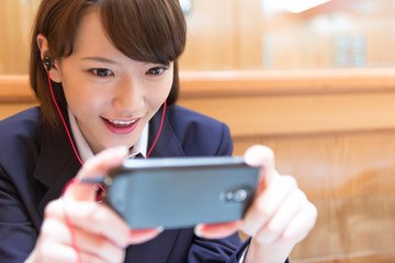 スマホを見る女子高校生