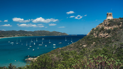 Panoramic view of a beautiful bay with yachts, blue water and old tower