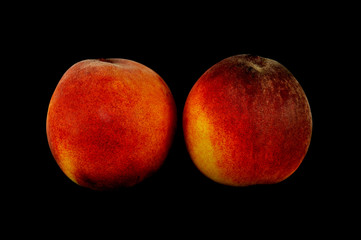 Juicy nectarines on a black background close up