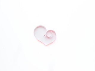 The heart is made of red paper on a white background. Valentine's Day.