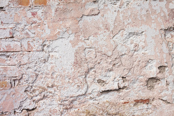 Empty old brick wall texture. Painted grungy wall surface.  Grunge red stonewall background. Shabby building facade with damaged plaster. Abstract web banner. Copy Space.