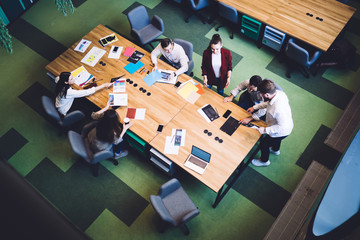 Modern coworkers at table in office conference room
