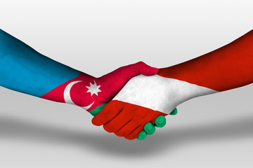 Handshake between austria and azerbaijan flags painted on hands, illustration with clipping path.