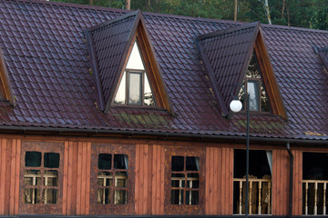 wooden house with a metal roof in the forest