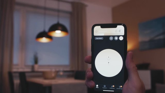 Mid shot  - Smart Home living room with intelligent LED lights. All lamps are easily turned on and off by a Phone app which stays in focus.