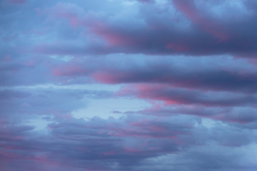 Cloudy sky with magenta and pink hue of sunset