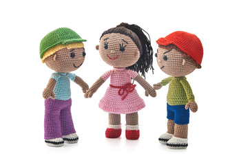 Knitted toys boys and girl on a white background