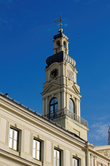 Fototapeta na wymiar White old clock tower in the Gothic style, Riga.