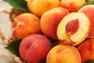 Fototapeta na wymiar A slice of juicy and ripe peach with a close-up stone. Cut fruit.