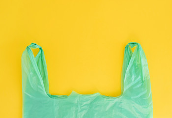 No Plastic. Plastic green Bag on yellow background. Recylcle Concept.Copy Space