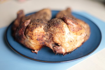 Dry rub spatchcock chicken resting on a plate.