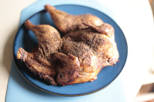 Dry Rub Spatchcock Chicken Resting On A Plate.