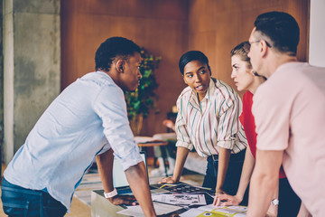 Multiracial people discussing creative ideas for developing startup project during brainstorming...