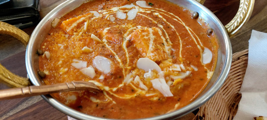 Indian food including curries, spice sauce and naan bread.