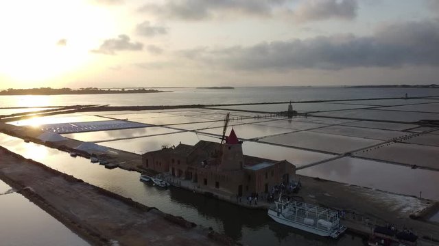 Scenic Sunset View Of Windmill In The Salt Pan Of Mazara Del Vallo, Sicily, Italy - aerial drone