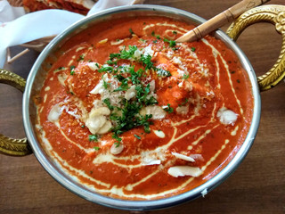 Indian food including curries, spice sauce and naan bread.
