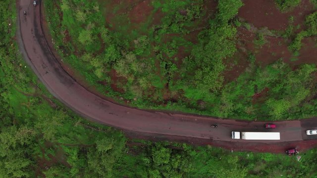 drone top shot of container  truck turning on mountain road Indian malvan