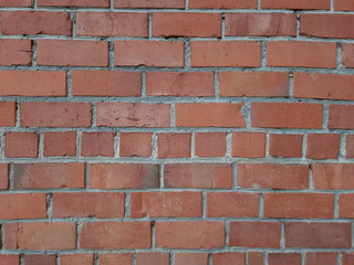 The texture of the outer part of the brick wall is red. Architecture, structure.