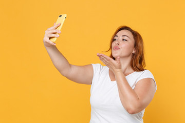 Pretty young redhead plus size body positive female woman girl in white casual t-shirt doing selfie...