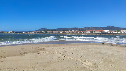 Waves of water of the river and the sea meet each other during high tide and low tide. Whirlpools of the Cavado River in Esposende, Portugal.