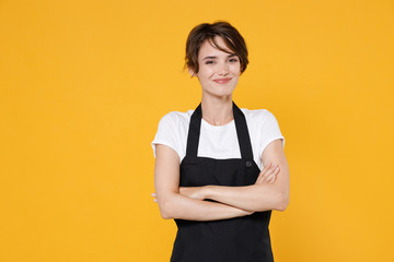 Smiling young female woman 20s barista bartender barman employee in white t-shirt apron work in...