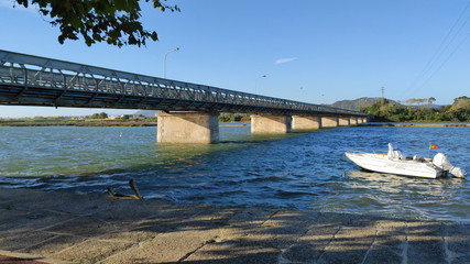 Fao / Esposende / Portugal -  August 22, 2020: The Fao metallic bridge, known as D. Lu&iacute;s Filipe Bridge. It is located at Fao in Braga District, crossing the C&aacute;vado River. The riverside promenade.