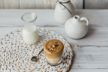 Dalgona whipped coffee, instant, cream, iced coffee. Cocktail with coffee, milk and ice cubes on white background mockup. Trendy drink background with copy space for text.