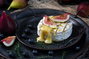 Camembert cheese baked with honey and garnished with figs, berries and thyme.