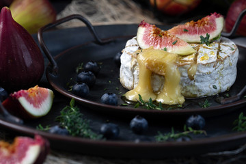 Camembert cheese baked with honey and garnished with figs, berries and thyme.