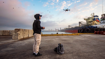 Young stylish dron pilot in seaport  © Nik Viatkin
